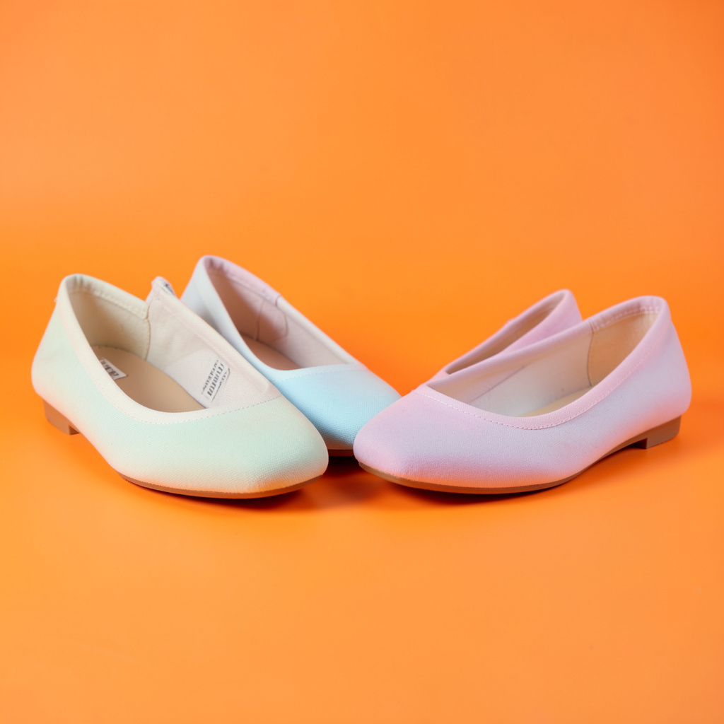 Canvas lonas and soft ballet flats in pastel tones, neatly lined up on a clean studio surface.