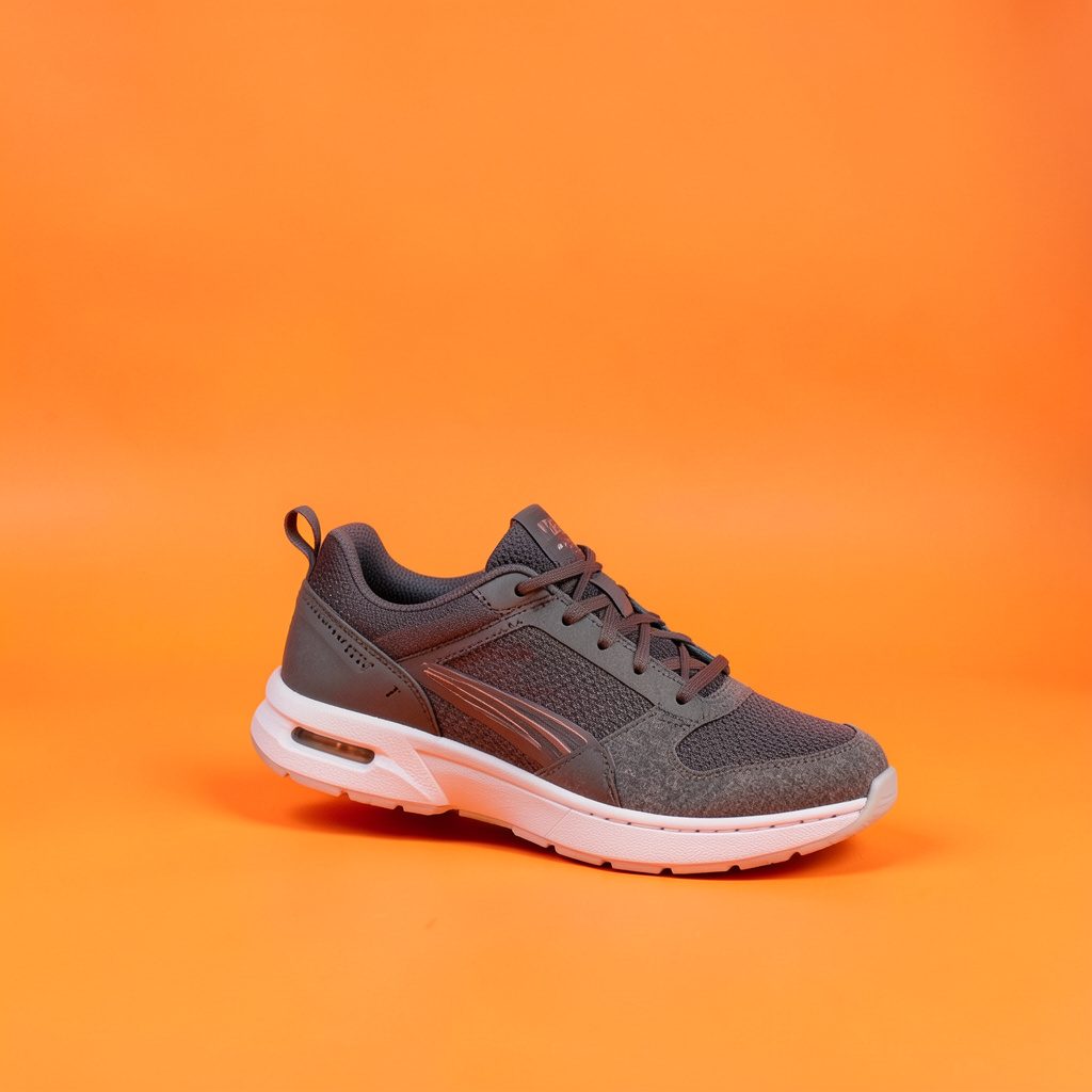 A single colorful children's sneaker displayed on a plain light backdrop, playful and tidy mood